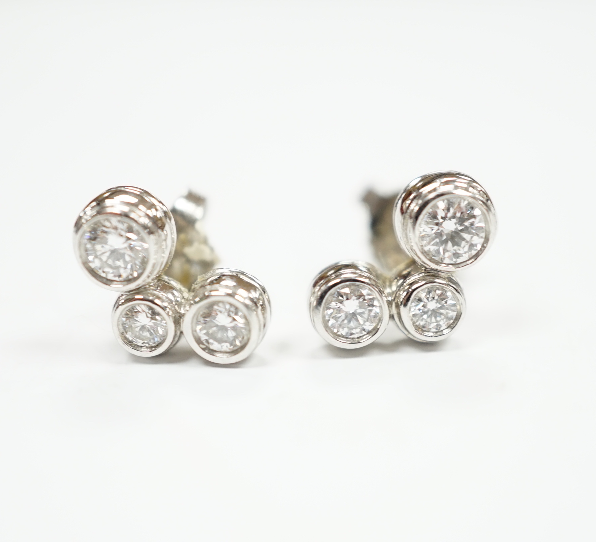 A modern pair of Tiffany & Co platinum and three stone graduated diamond set ear studs, 10mm, gross weight 4.1 grams.